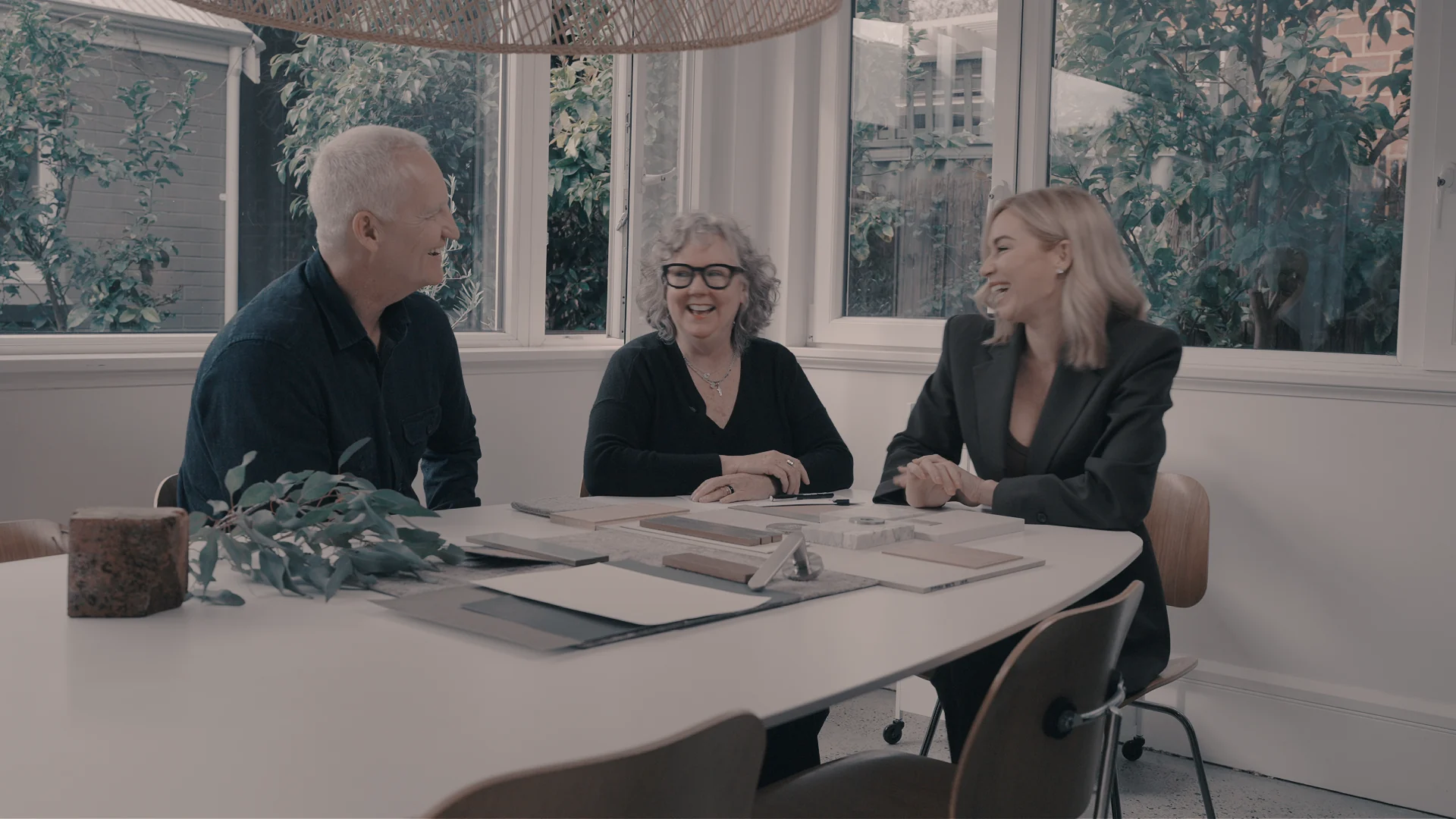 Paul Lakey, Charlotte Kennedy and Sarah Beale sharing a laugh around the material table